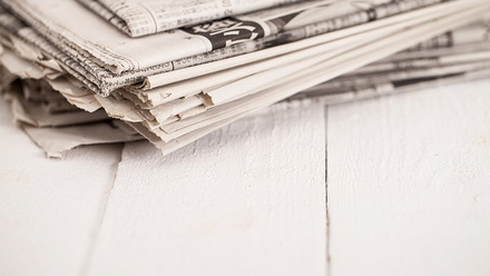 pile-newspapers-white-table - medium.jpg 1